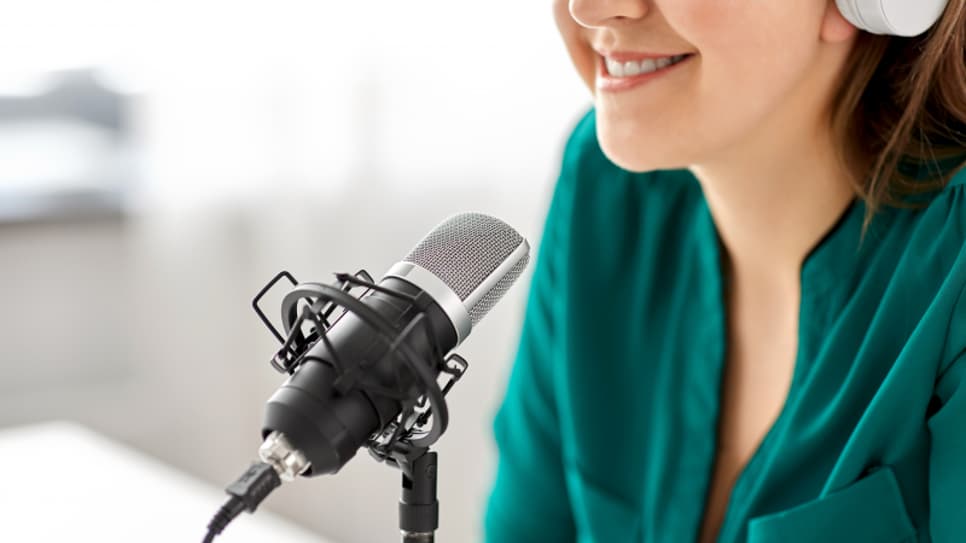 32200108-woman-with-microphone-recording-podcast-at-studio.jpg