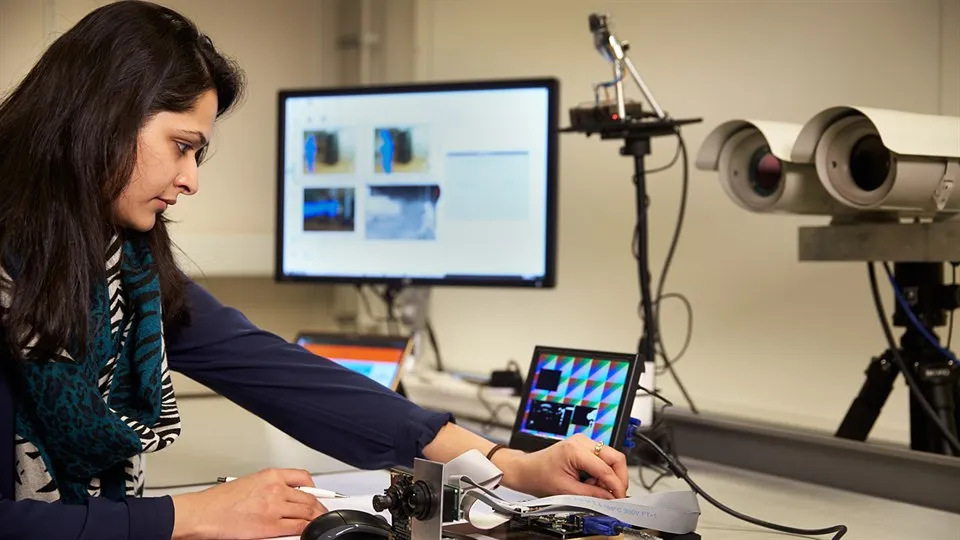 Woman using camera equipment in a lab.