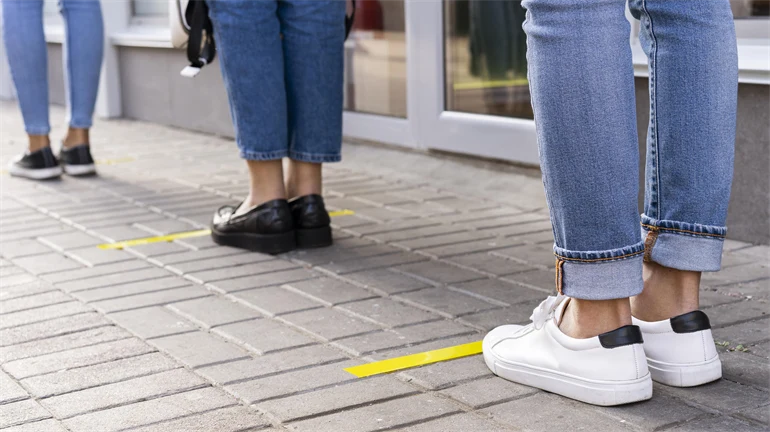 People standing in line one meter apart.