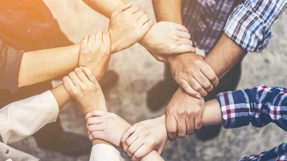 Eight hands that hold on to the next wrist to make a safe circle.
