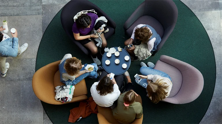 Students around a table, helicopter perspective.