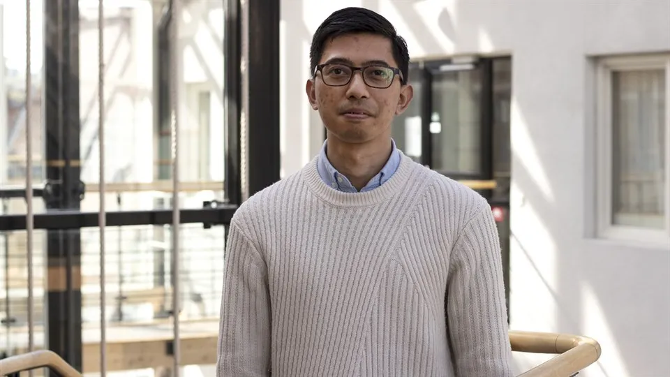 Man with glasses and dark hair.