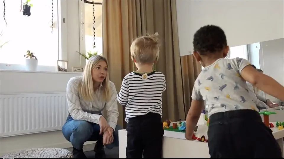 Woman sitting, two children playing
