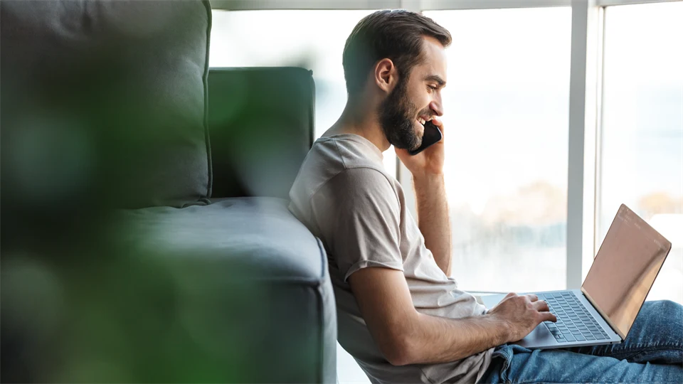 Young man with mobile and computer