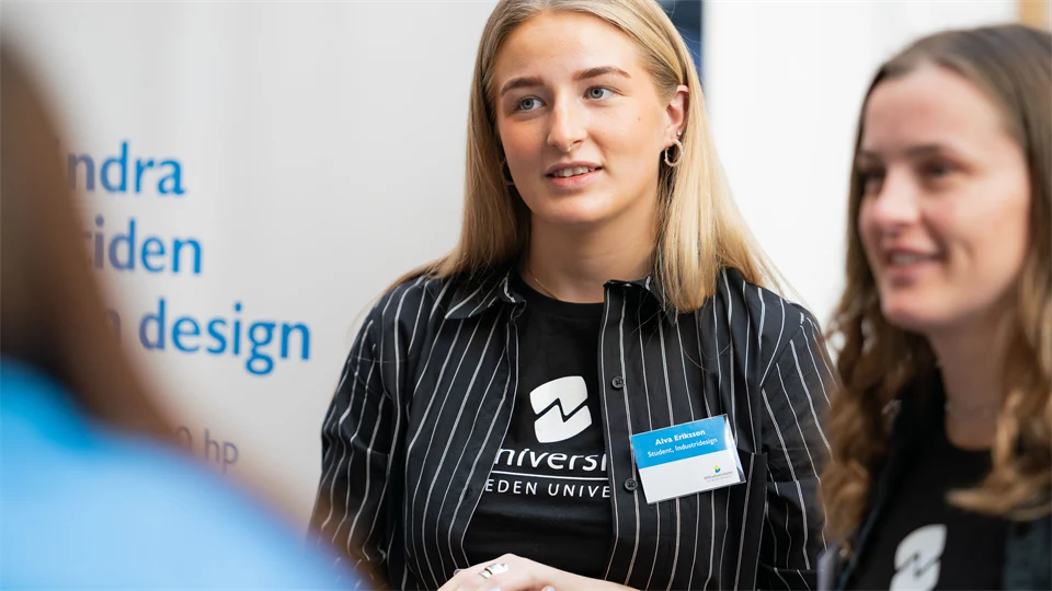 Two student ambassadors working in a booth.