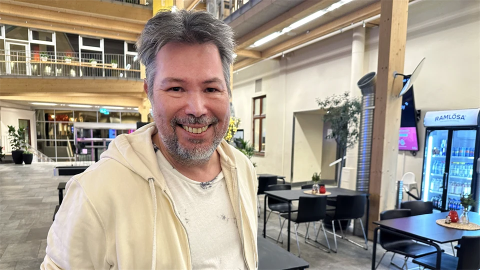 a man that smiles to the camera