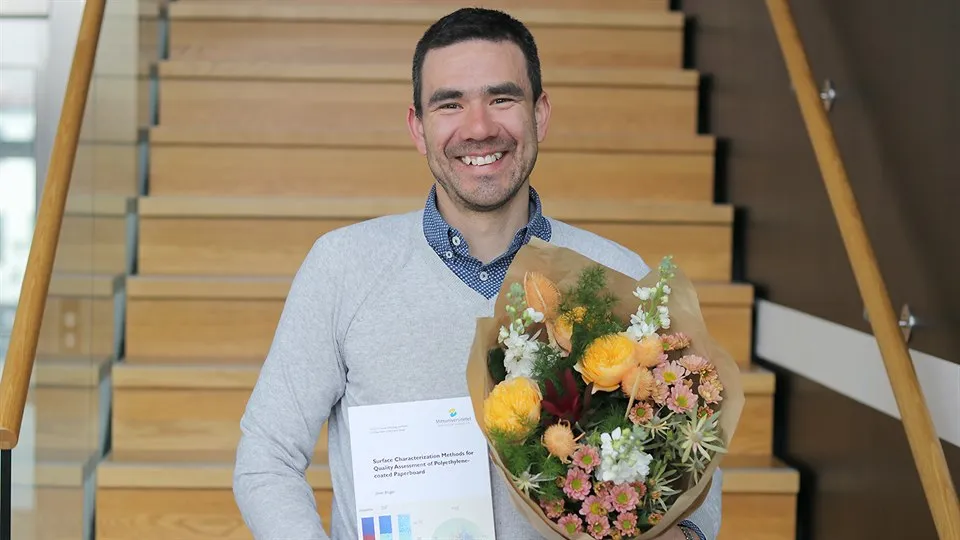 Bild på nydisputerad Javier Brugés med blommor i handen