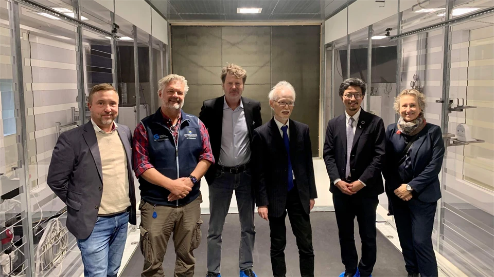 Five men and one woman smiling at the camera