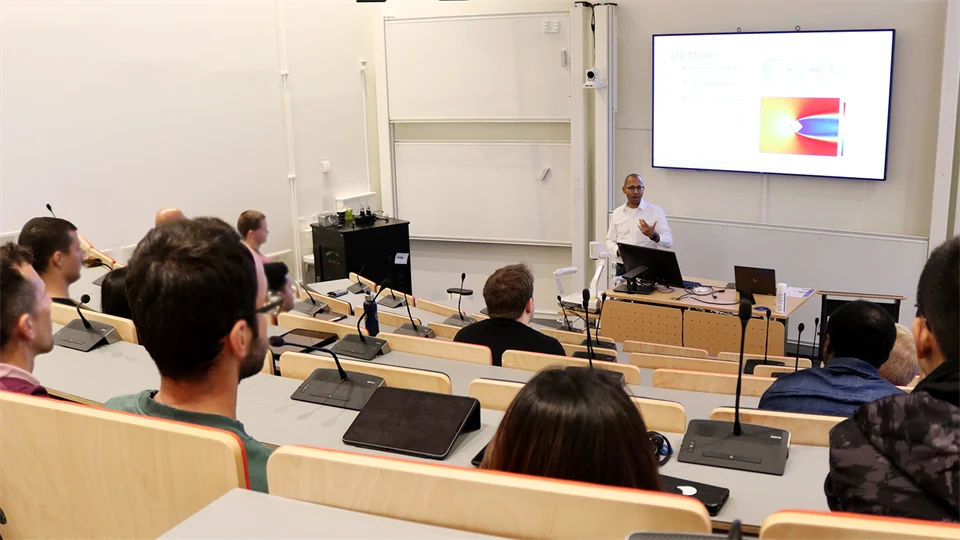 Lecture hall with the audience listening to a speaker.