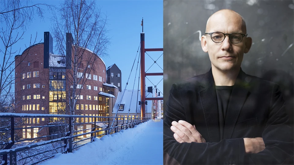 till vänster en rund byggnad i tegel, till höger en skallig man med glasögon och armar korsade över bröstet