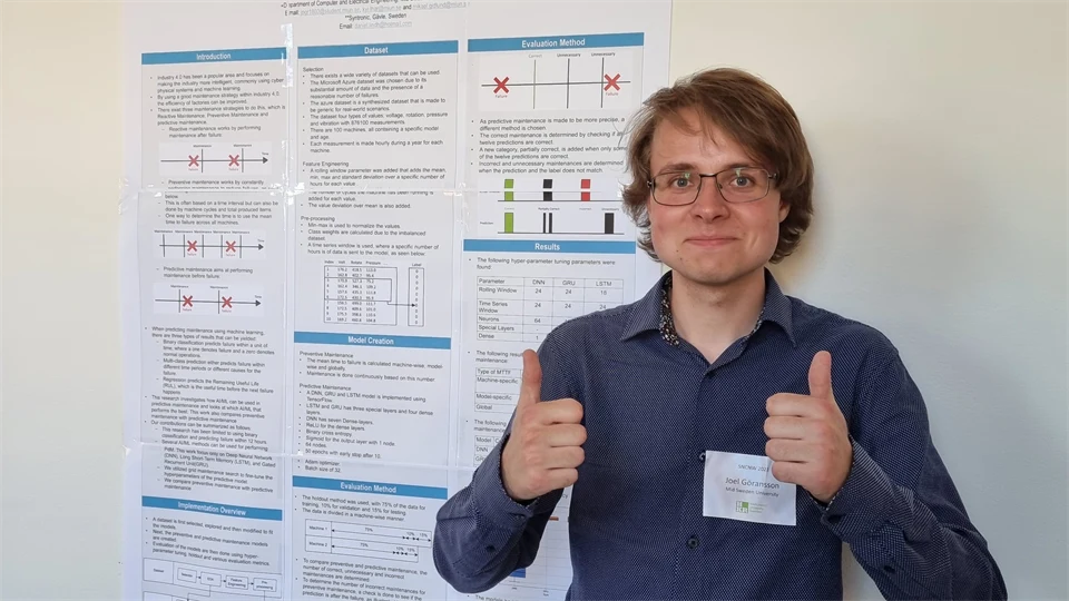 a person is standing in front of a sign and is showing his thumbs up