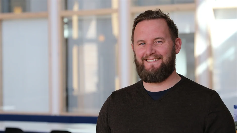 Portrait of a smiling man with a beard.
